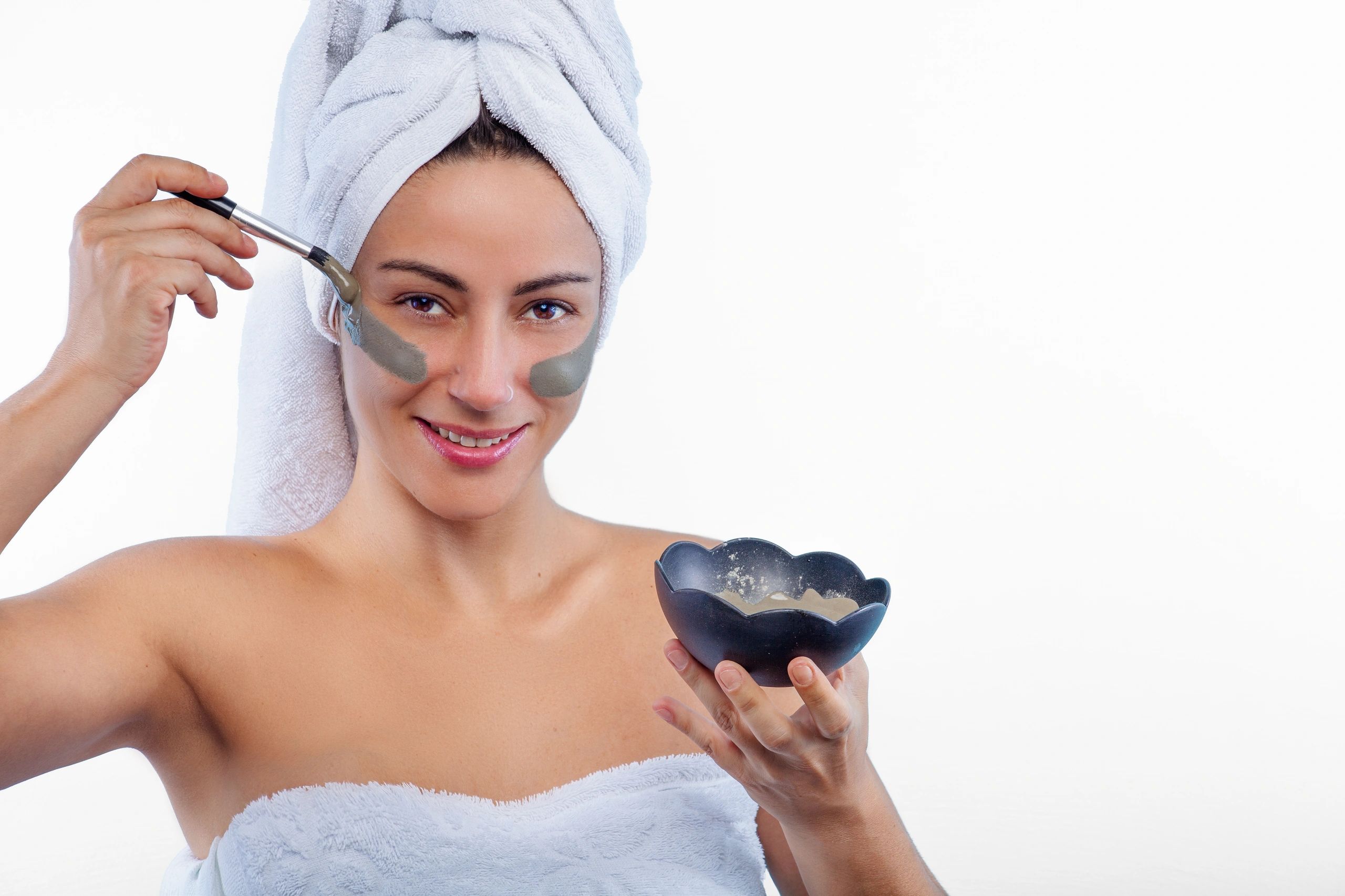 Woman applying a facial mask